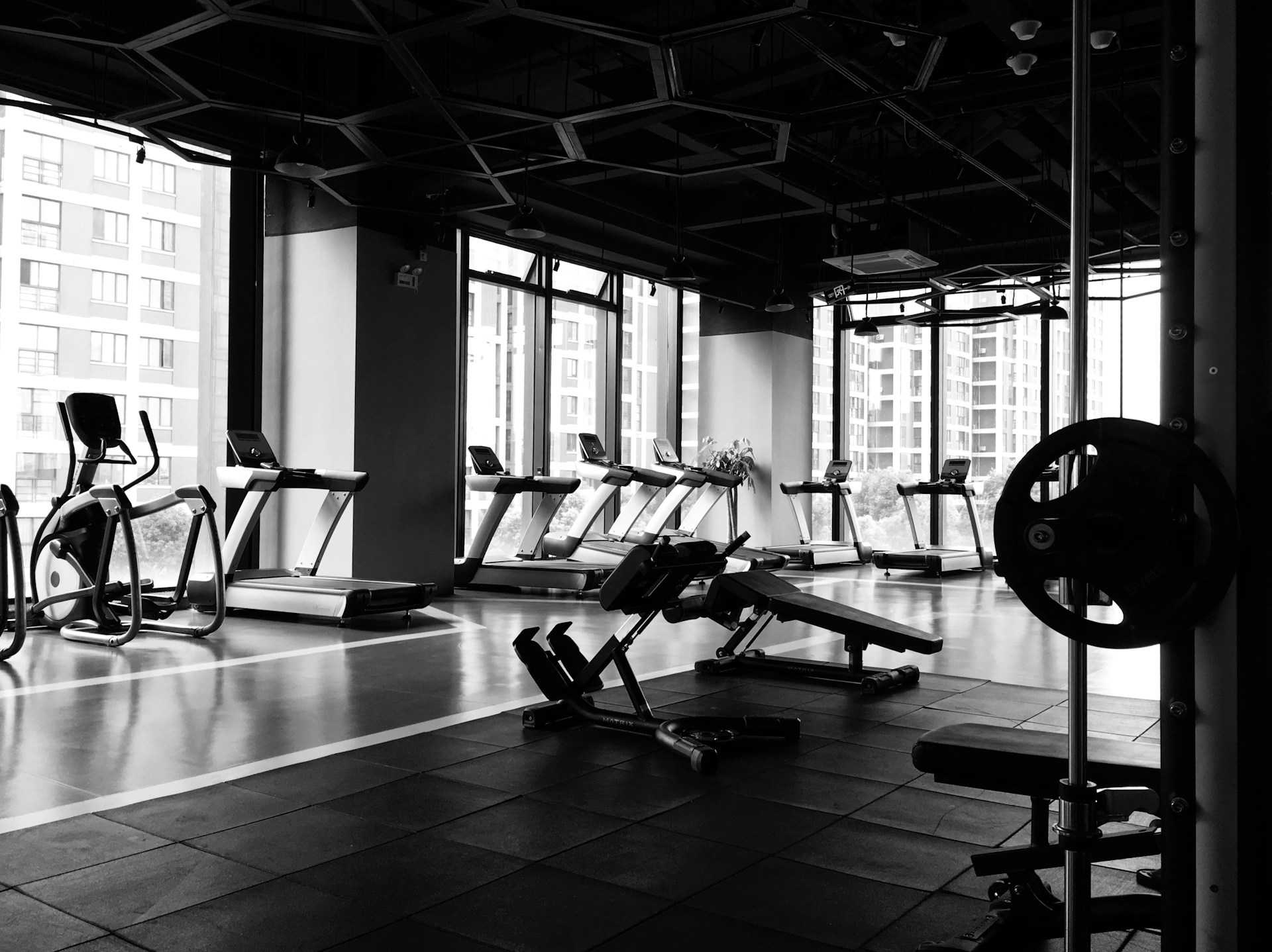 Fitness room, treadmills, rubber mats, weight bench, barbell, weight plates